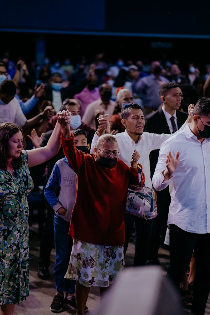 Crafting Captivating Headlines: Your awesome post title goes here A diverse group wearing masks participates in a worship event indoors.